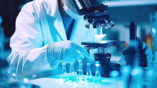 Scientist viewing a microscope in a laboratory